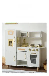Detail of wooden play kitchen featuring white cabinets with golden faucet and hardware
