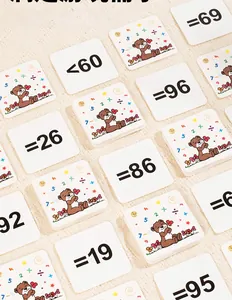 Macro shot of educational math flashcards with numbers and bears on textured fabric