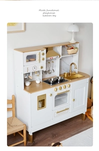 Detailed side view of wooden play kitchen toy set with gold hardware and accessories