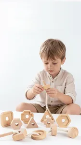 Toddler hand threading a wooden geometric block with a needle to improve motor skills