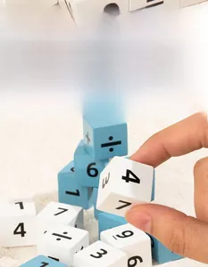Close-up of smooth wooden math blocks with printed numbers and symbols for kids