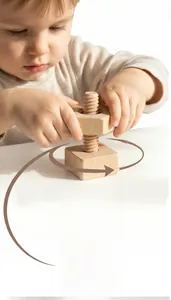 Toddler hands twisting a hexagonal wooden nut on a square bolt for fine motor skills
