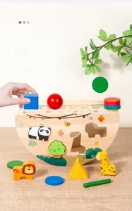 Close-up of wooden Montessori toy with animal blocks and geometric shapes on balance base