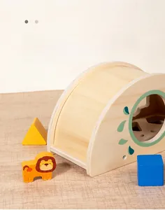 Detail view of smooth wooden Montessori shape box with lion block and geometry pieces