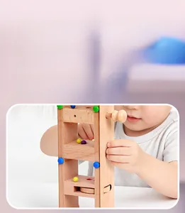 Detail of wooden logic puzzle board showing interactive manual control knobs and marble maze