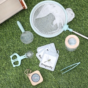 Wooden kids outdoor bug catching kit with insect net, magnifier and cards on grass