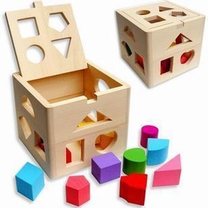 Macro view of thirteen-hole wooden shape sorter box with colorful geometric blocks