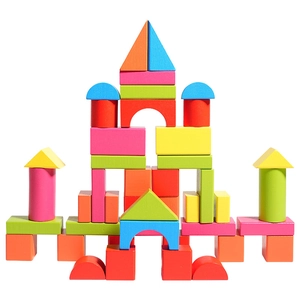 Colorful natural beech wood building block set arranged in a symmetric castle on white background