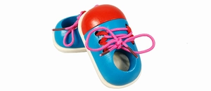 Close-up of wooden lacing shoe toy in blue and red for teaching kids to tie shoelaces