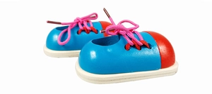 Close-up of sky blue wooden lacing shoe toy with red toe and pink laces for kids