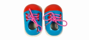 Close-up of colorful wooden educational shoes for children to practice lacing and tying
