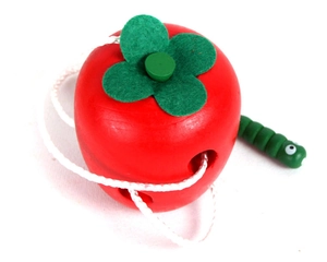 Detailed macro view of children's wooden apple lacing toy with caterpillar threader