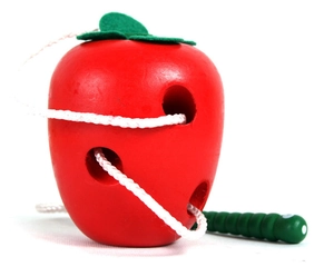 Detail of wooden apple lacing toy with a green caterpillar threader for fine motor skills