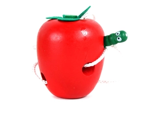 Detail of wooden threading toy showing green caterpillar eating through a red apple