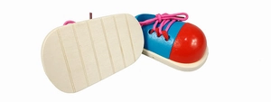 Detail of wooden shoe tying toy showing blue body, red toe cap and pink cotton laces