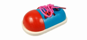 Detail of wooden shoe tying toy with pink laces for kids fine motor skills practice