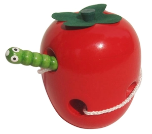 Detail of wooden apple threading toy with green caterpillar needle for motor skills