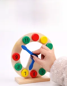 Detailed close-up of a wooden teaching clock with colorful numbered blocks and blue hands