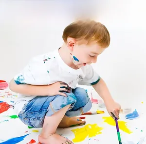 Detail of eco-friendly water-based paints and brushes for wooden educational toys
