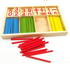 Macro view of wooden counting sticks and math symbol blocks in a sectioned storage box