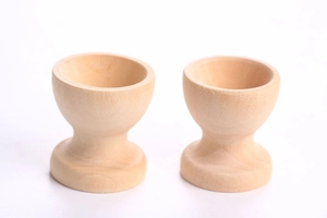 Macro view of natural wooden egg cups with polished finish for DIY crafts and pretend play