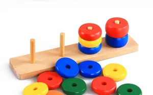 Detailed macro view of colorful wooden stacking rings and pillars on a natural round base