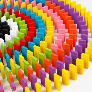 Overhead macro shot of colorful wooden domino tiles arranged in a creative spiral pattern