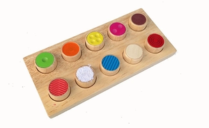 Macro view of sensory wood toy with colorful tactile inserts for early education