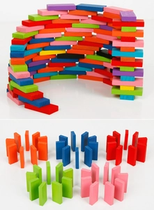 Macro shot of colorful wooden domino blocks arranged in creative patterns and circles