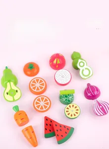 Macro shot of assorted wooden magnetic fruits and vegetables on a pink background