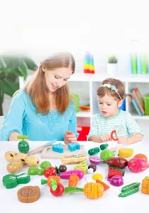 Detail of wooden play food set with magnetic fruits, vegetables and cutting tools