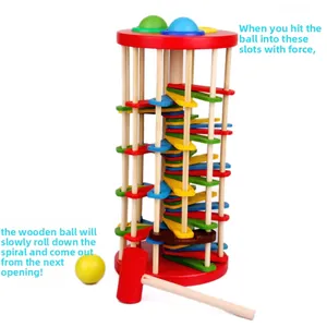 Detail of wooden ball tower with rainbow slides and red mallet for motor skill training