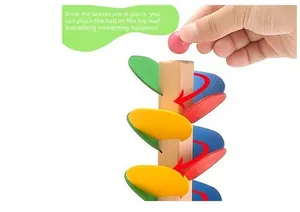 Detail showing the colorful wooden petals and small ball rolling down the tower track
