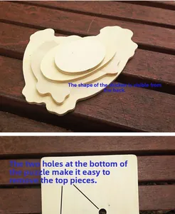 Detail of wooden chicken puzzle layers with two holes at bottom for easy piece removal