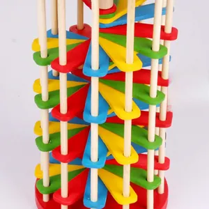Macro detail of wooden spiral staircase toy with vibrant red yellow blue and green blocks
