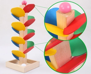 Detailed view of colorful wooden leaf marble run toy with smooth spiral petal tiers