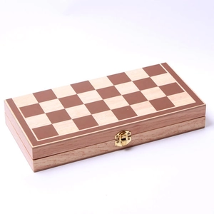 Detail of wooden folding chess board with wood grain grid and golden metal clasp