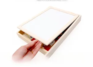 Detailed view of the wooden educational puzzle storage box and magnetic white drawing board