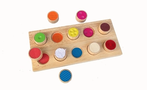 Detail of tactile sensory wooden toy with 12 colorful textured blocks for toddler learning