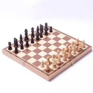 Top-down view of a foldable wooden chess set with detailed pieces on a wood grain board