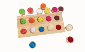Detail of wooden sensory board with colorful tactile matching pieces for kids