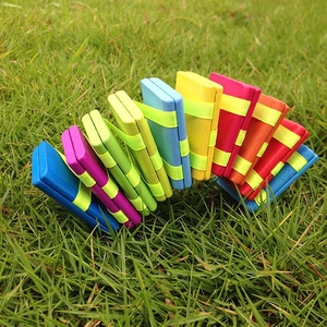 Classic colorful wooden Jacob's ladder toy arched on green grass for motor skills