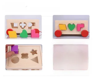 Detail of child hands matching colorful wooden geometric shapes into the puzzle car toy