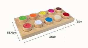 Detail view of Montessori wooden sensory board with textured color cylinders and dimensions