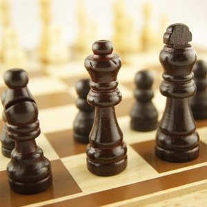 Macro shot of dark brown polished wooden chess pieces with detailed natural grain