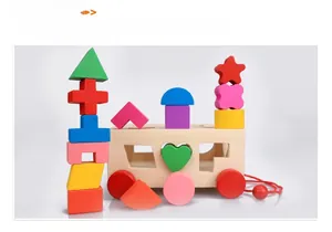 Detail of colorful wooden shape sorter blocks stacked near a classic pull-along wagon