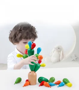Young boy focusing on building a colorful wooden cactus puzzle educational toy for kids