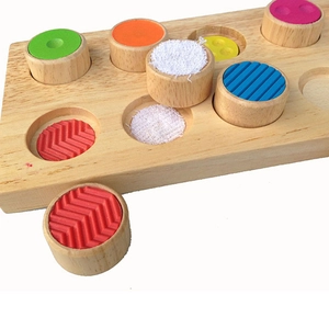 Kids wooden sensory texture matching toy with colorful tactile blocks on a natural base
