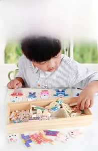 Detail of wooden rabbit dress-up puzzle set with colorful outfit pieces in a storage box