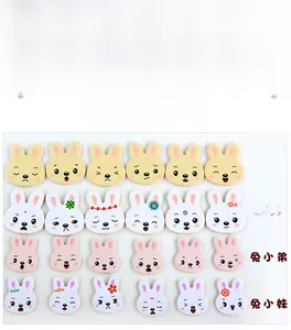 Detail of 24 wooden rabbit puzzle pieces showing various facial expressions for kids